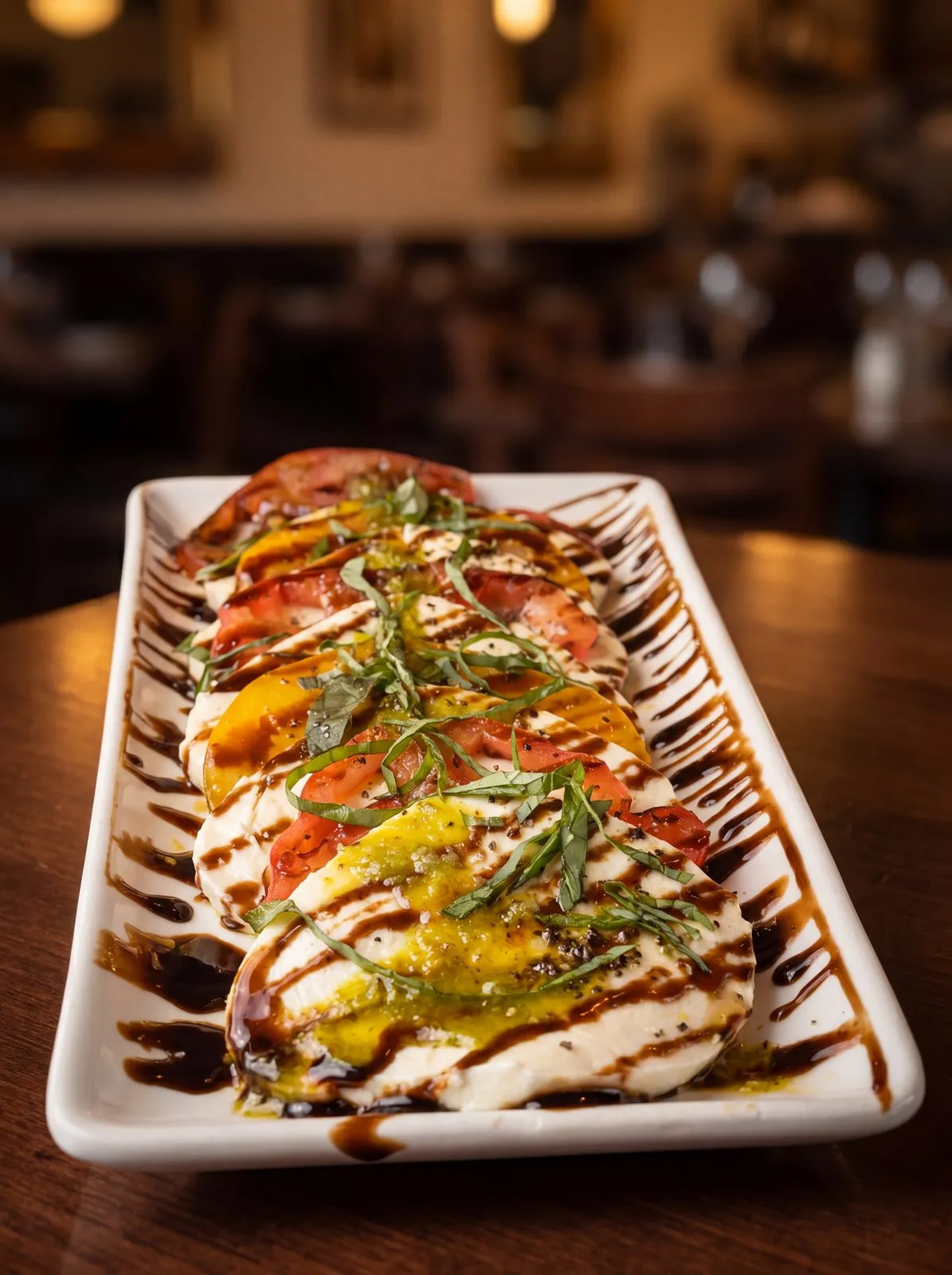 Caprese with tomato, mozzarella and basil.