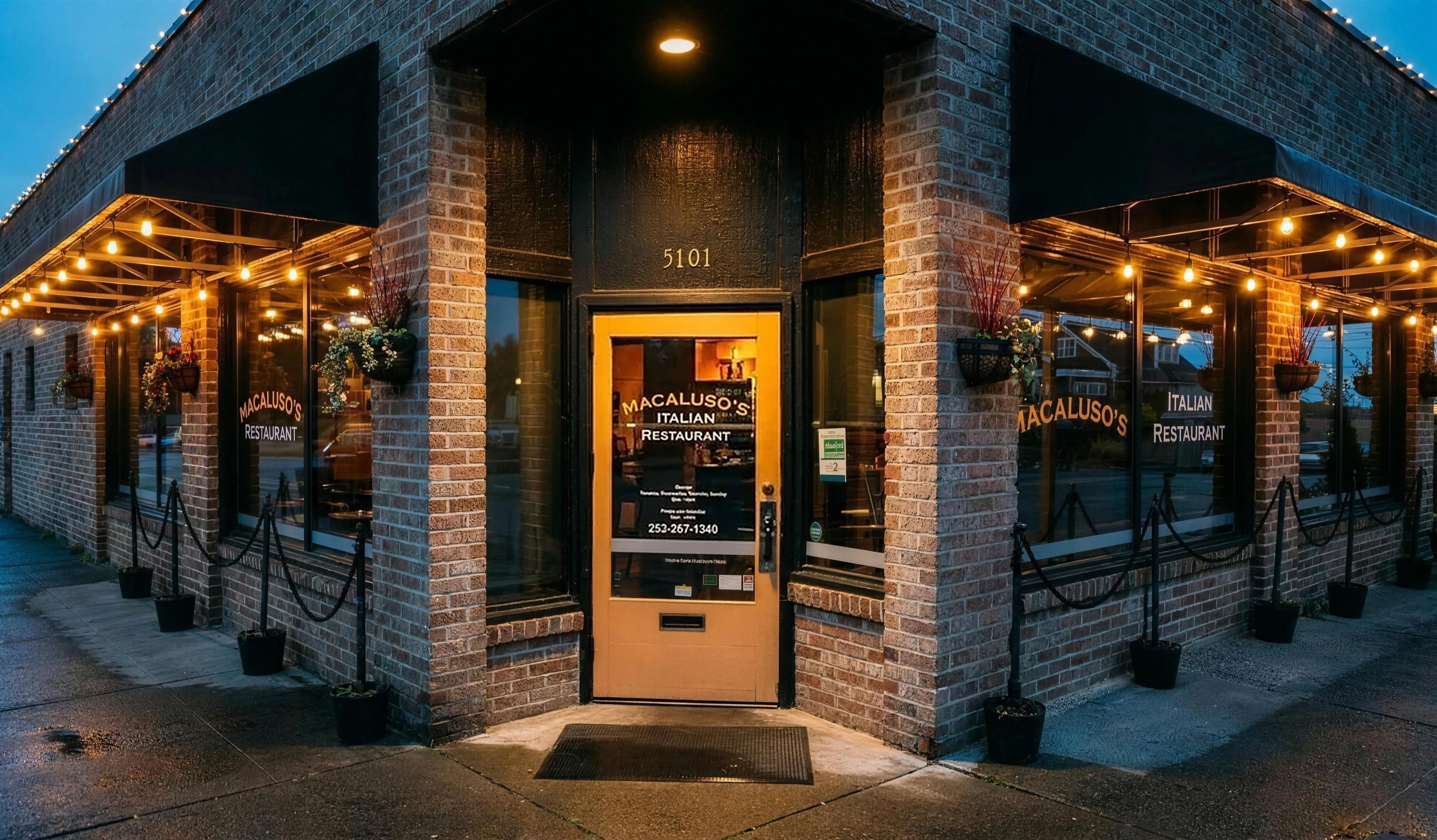 The brick corner storefront at dusk, string lights glowing.